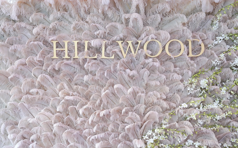 Step and repeat featuring Hillwood's logo