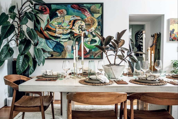 Image of a tablescape from Carter's book "Living Wild." It features houseplants as the main decorative feature of the table and room.