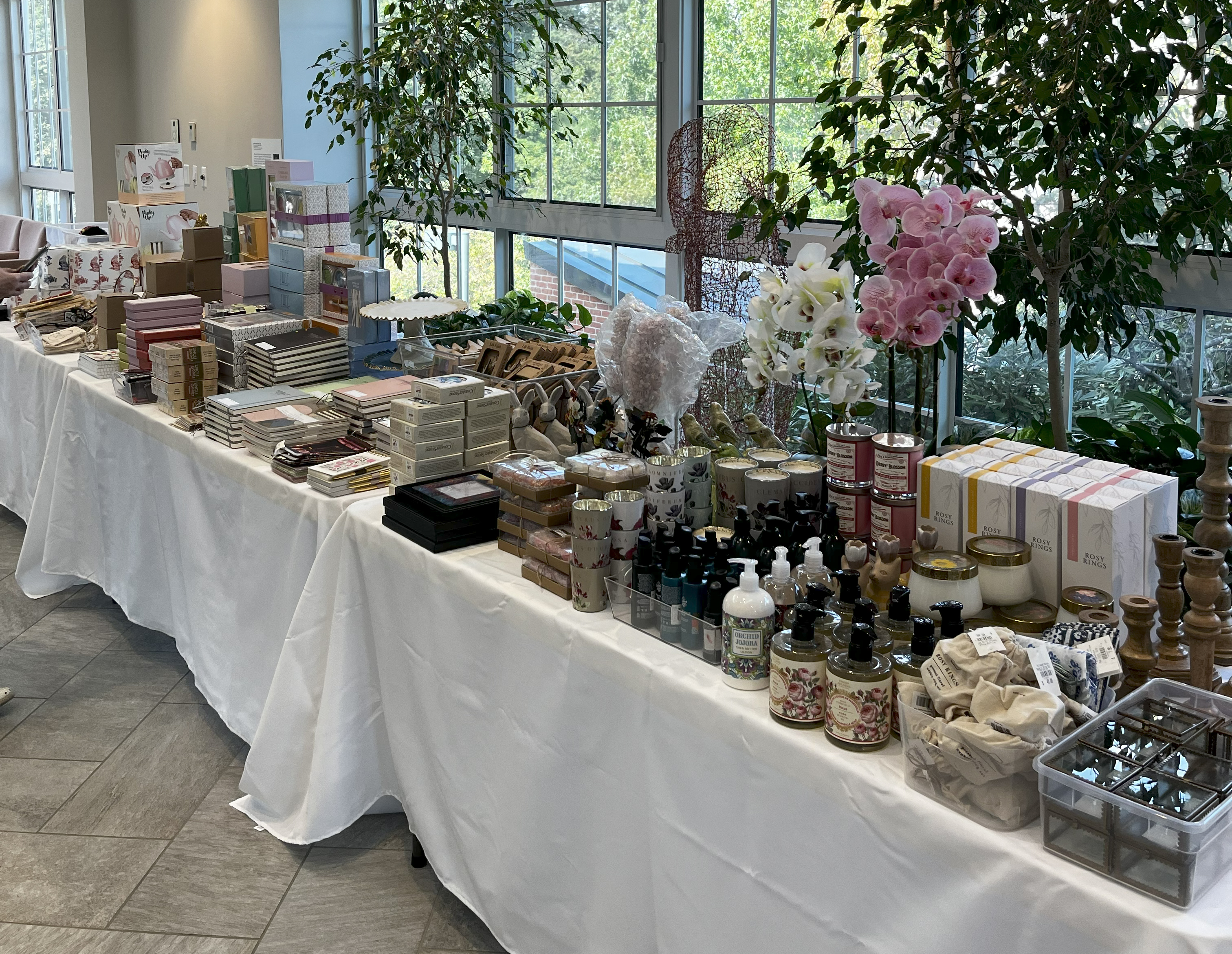 Sidewalk Sale set up in the Conservatory with goods laid out on tables