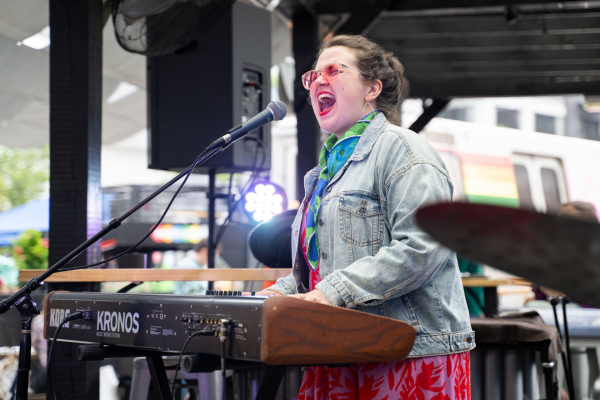 Image of Amy K Bormet playing the keyboard and singing.
