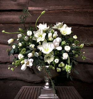 Luscious floral arrangement featuring white flowers with silver accents