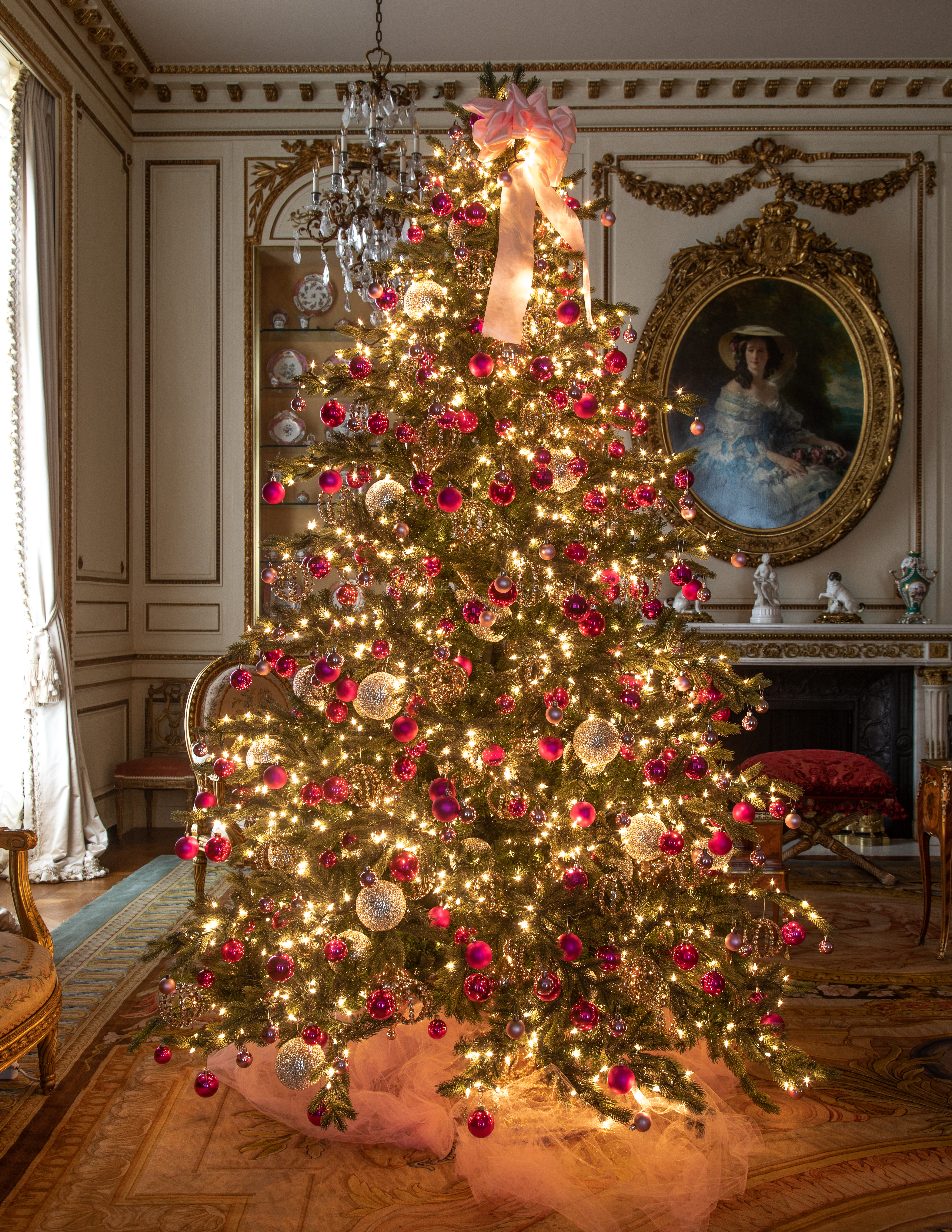 Image of Christmas Tree decorated with pink ornaments inside the mansion.