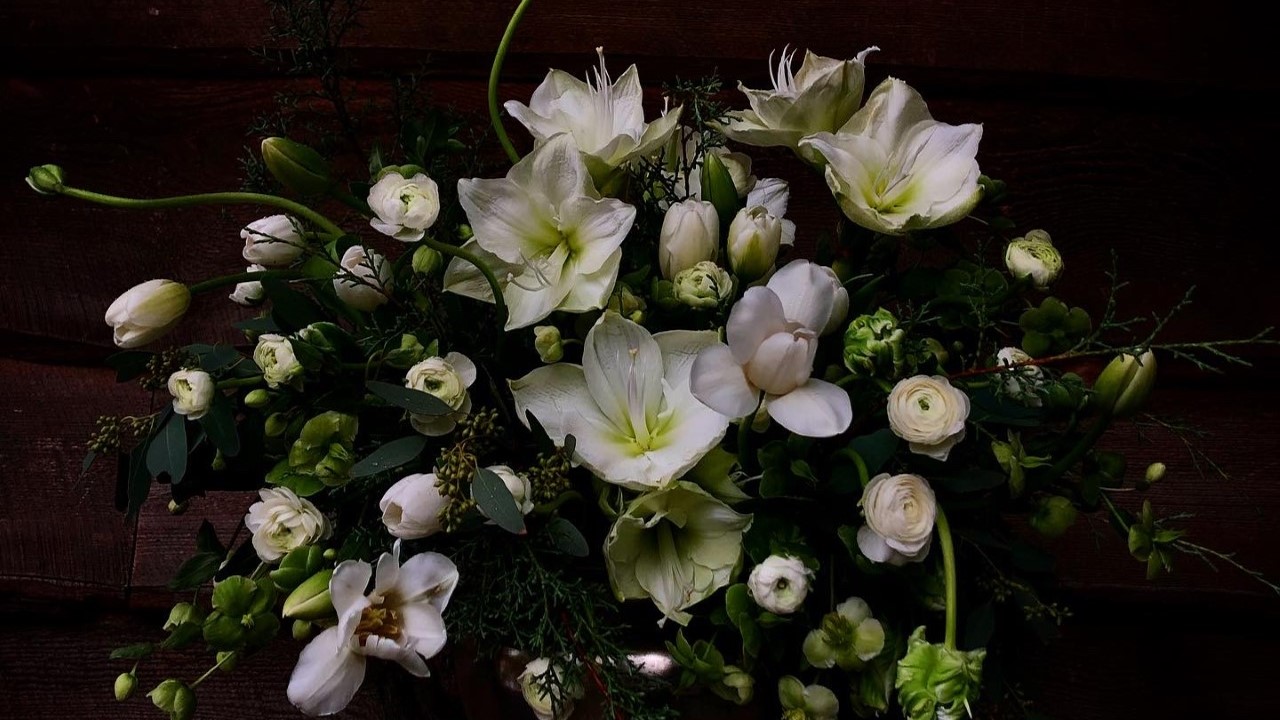 an arrangement of white and pale blue flowers