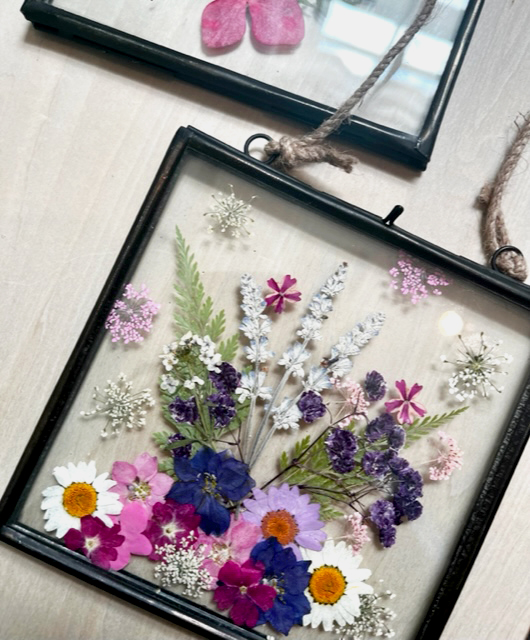 Hanging glass frame with pressed floral arrangement 