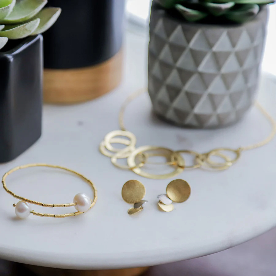 Selection of ABW Designs jewelry on a table