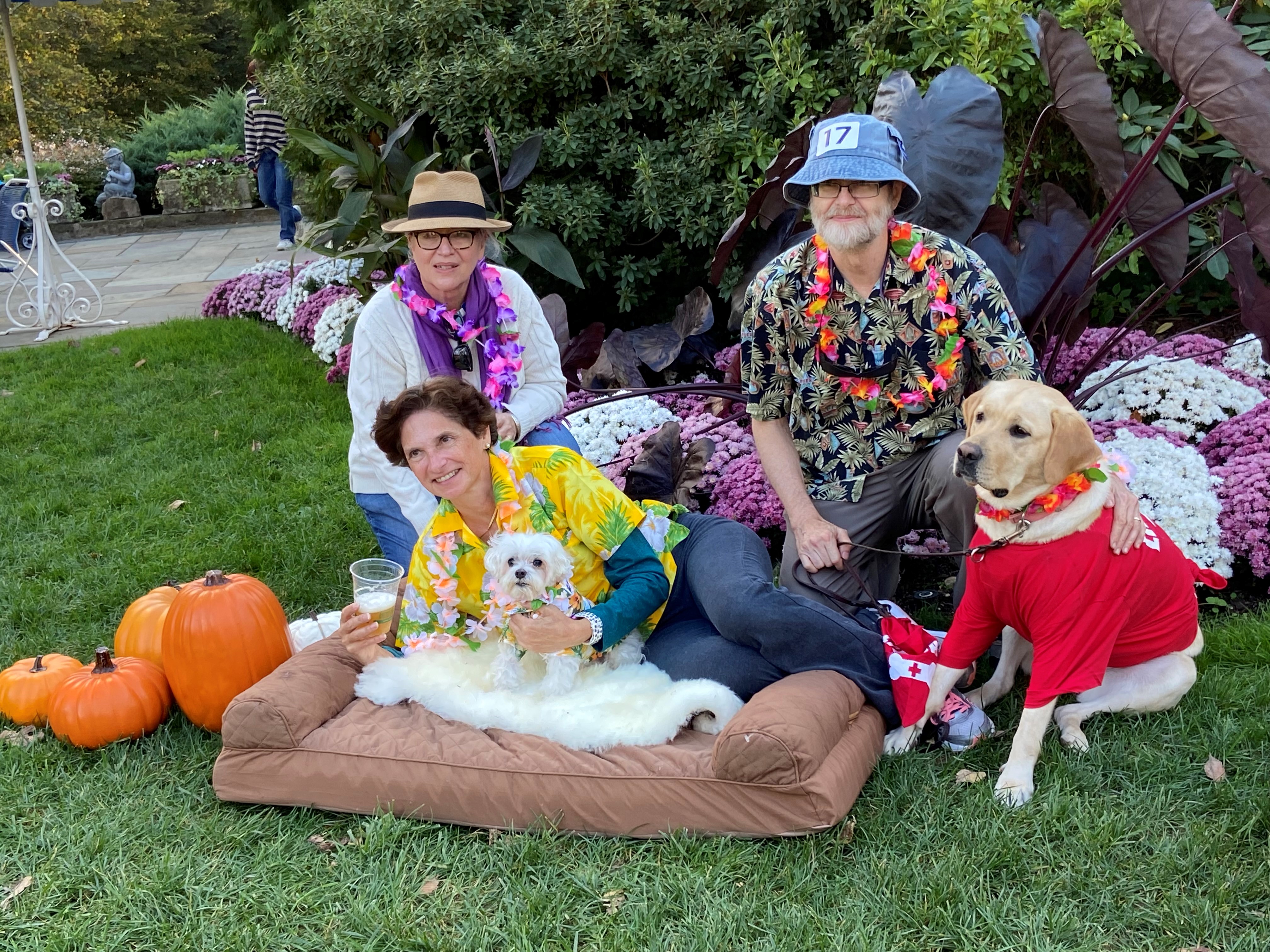 Group photo of 3 adults with 2 dogs relaxing on lunar Lawn