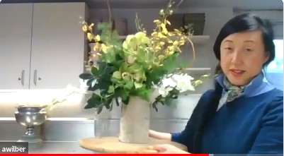 Screenshot of Ami Wilbur creating a floral arrangement over Zoom