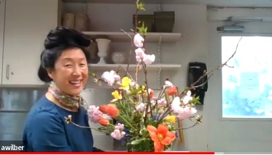 Screenshot of Ami Wilbur creating a floral arrangement over Zoom