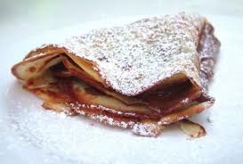 golden crepes covered in powdered sugar.
