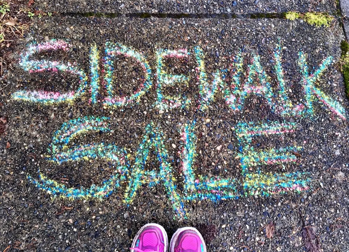 Sidewalk Sale written in chalk on a sidewalk