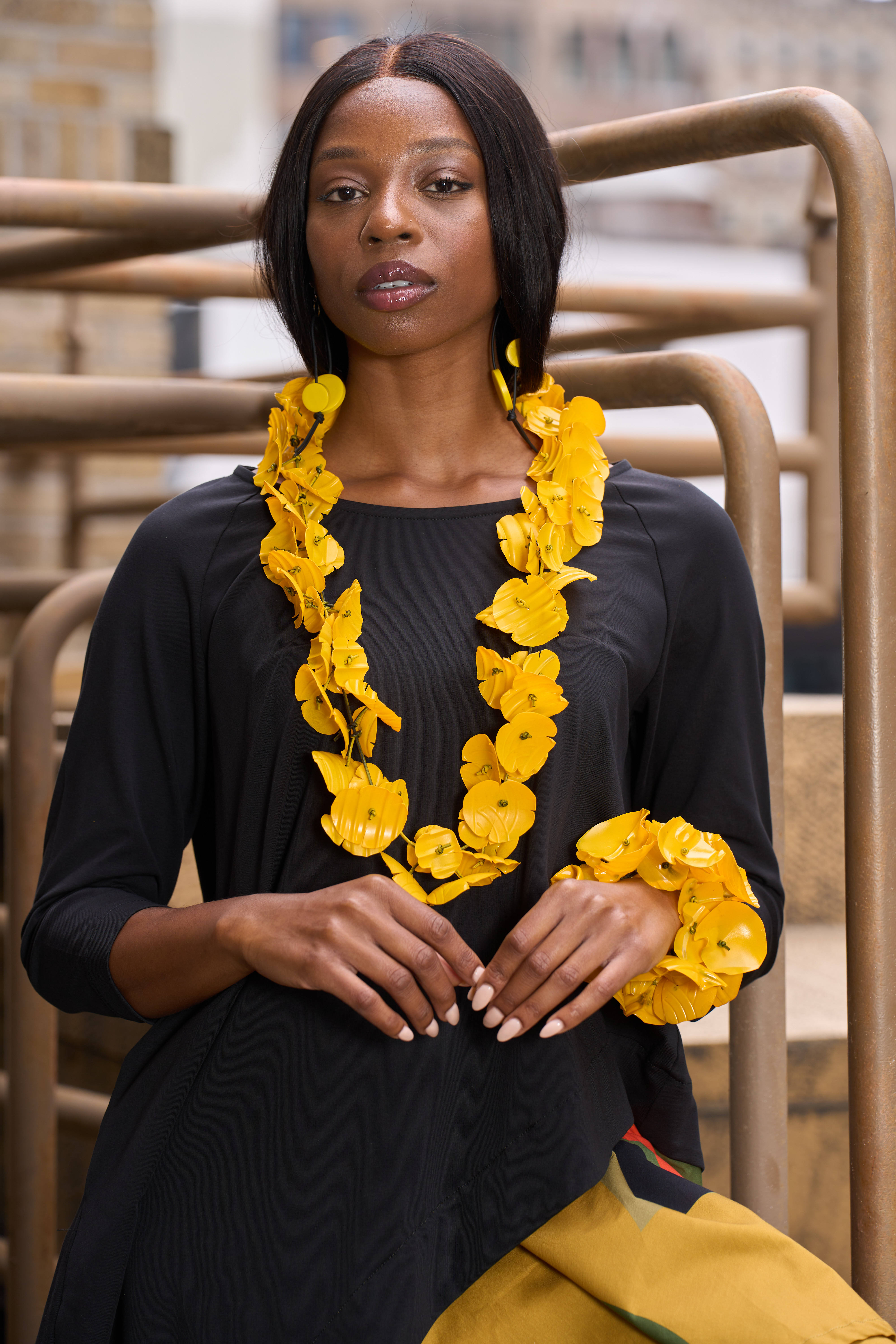 Black model wearing yellow necklace and bracelet from Jianhui