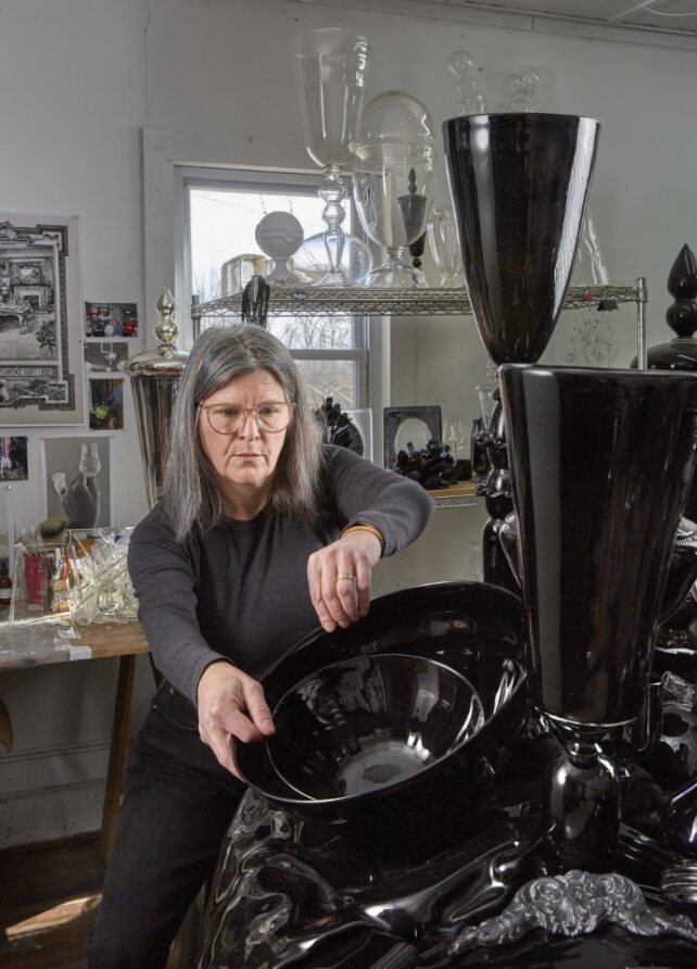 Photo of Beth Lipman at work in her studio.