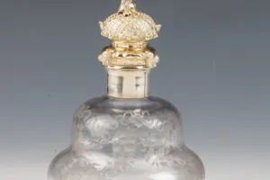 LARGE GLASS BOTTLE WITH STOPPER FROM A DRESSING TABLE SET (ONE OF TWO)