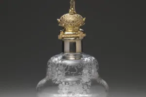 LARGE GLASS BOTTLE WITH STOPPER FROM A DRESSING TABLE SET (ONE OF TWO)
