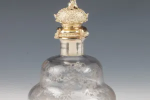 LARGE GLASS BOTTLE WITH STOPPER FROM A DRESSING TABLE SET (ONE OF TWO)