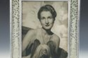 FRAME WITH PHOTOGRAPH OF ELEANOR POST CLOSE WITH A DOG