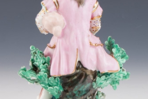 FIGURINE OF A BAGPIPER, ONE OF TWO