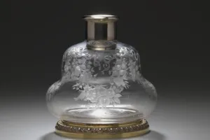 LARGE GLASS BOTTLE WITH STOPPER FROM A DRESSING TABLE SET (ONE OF TWO)