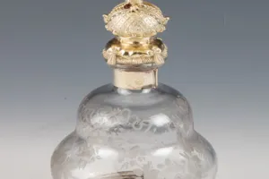 LARGE GLASS BOTTLE WITH STOPPER FROM A DRESSING TABLE SET (ONE OF TWO)
