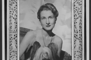 FRAME WITH PHOTOGRAPH OF ELEANOR POST CLOSE WITH A DOG