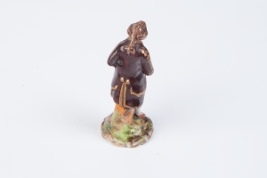 FIGURINE OF A YOUNG MAN, ONE OF A PAIR