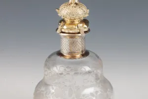 SMALL GLASS BOTTLE WITH STOPPER FROM A DRESSING TABLE SET (ONE OF TWO)