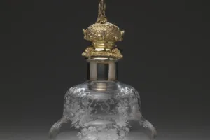 LARGE GLASS BOTTLE WITH STOPPER FROM A DRESSING TABLE SET (ONE OF TWO)