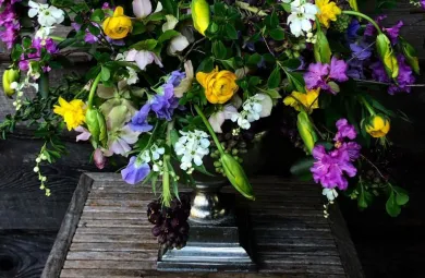 Luscious spring floral arrangement including blue, pink, purple, yellow and white flowers