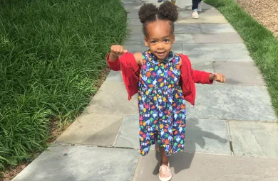 preschooler walking happily down a path through Hillwood's gardens