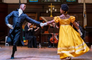 Image of two dancers, mid performance. 