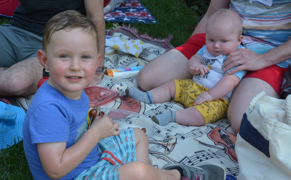 Young boy and baby picnicking