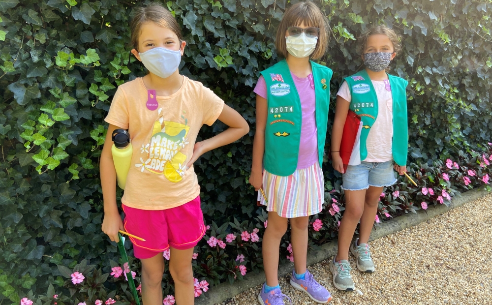 Girl Scouts standing in gardens