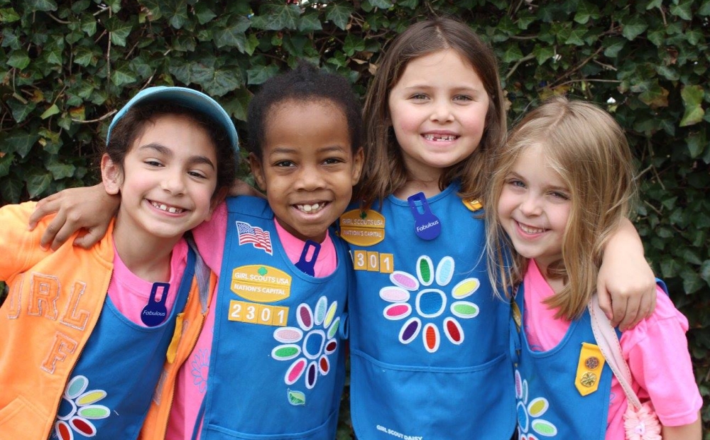 Daisy Girl Scouts posing in the gardens and smiling