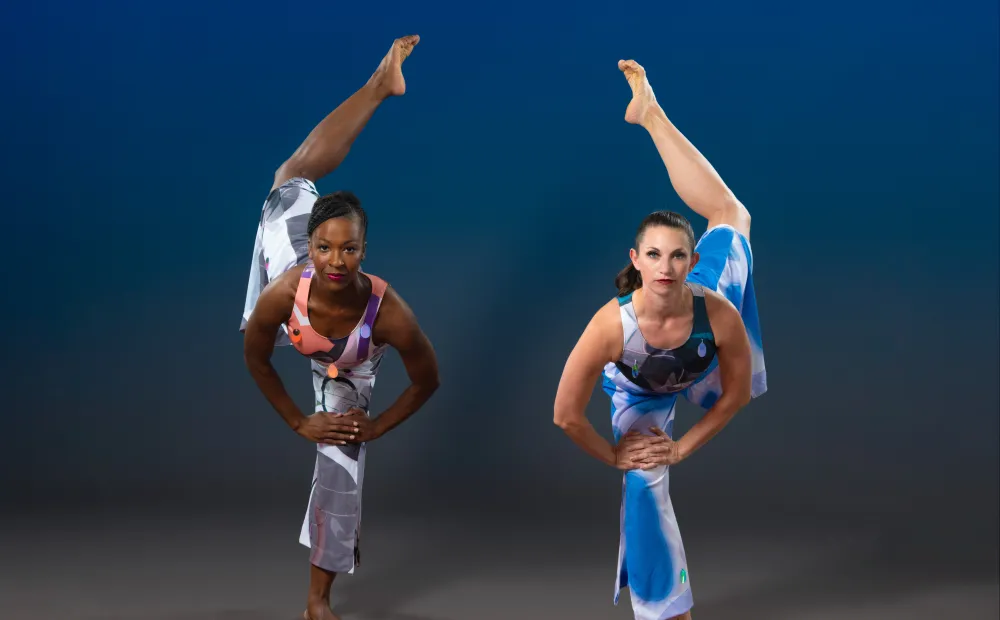 Image of two dancers posting, with their poses reflecting each other.