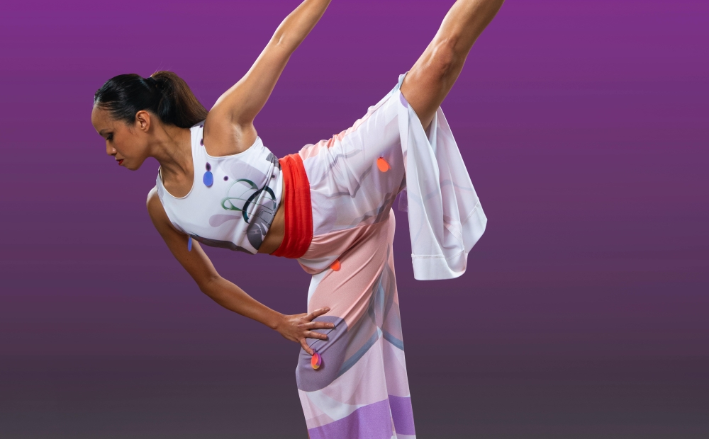 Image of dancer posing with arm and leg extended.