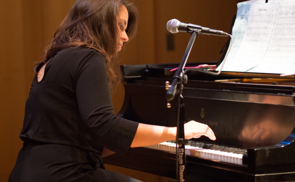 Amy K Bormet playing the piano.