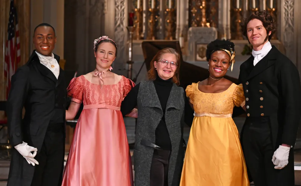 Image of dancers posing for a picture with the NYBDC director. 