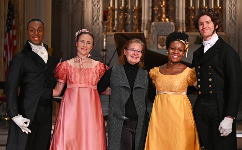 Image of dancers posing for a picture with the NYBDC director. 