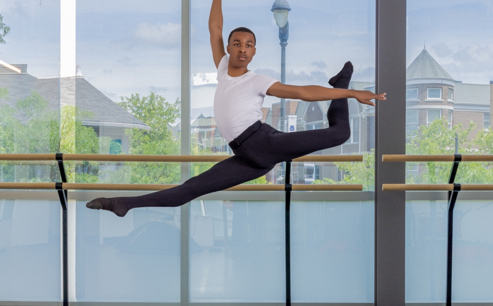 Image of a young dancer leaping through the air. 