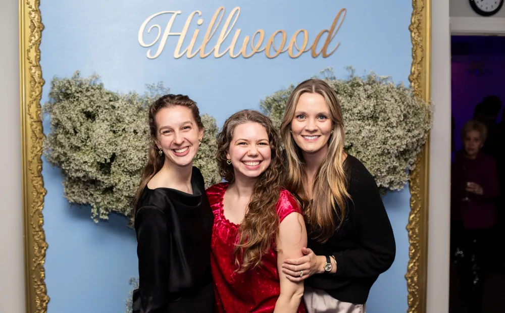 Three woman in front of step and repeat
