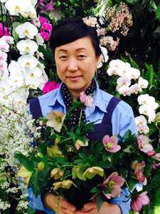 Ami Wilbur surrounded orchids in Hillwood's greenhouse